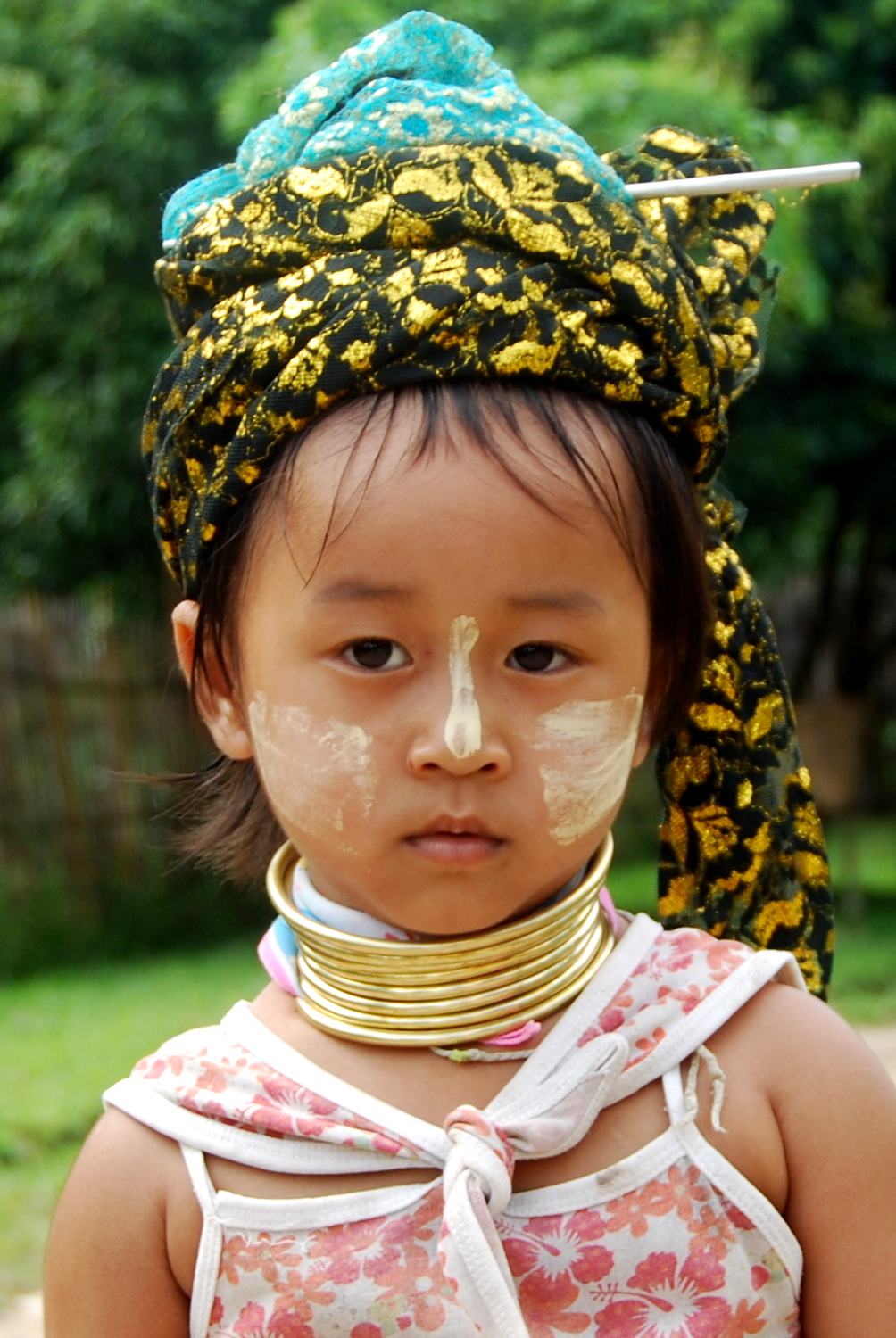 young child with decorative makeup and head wrap