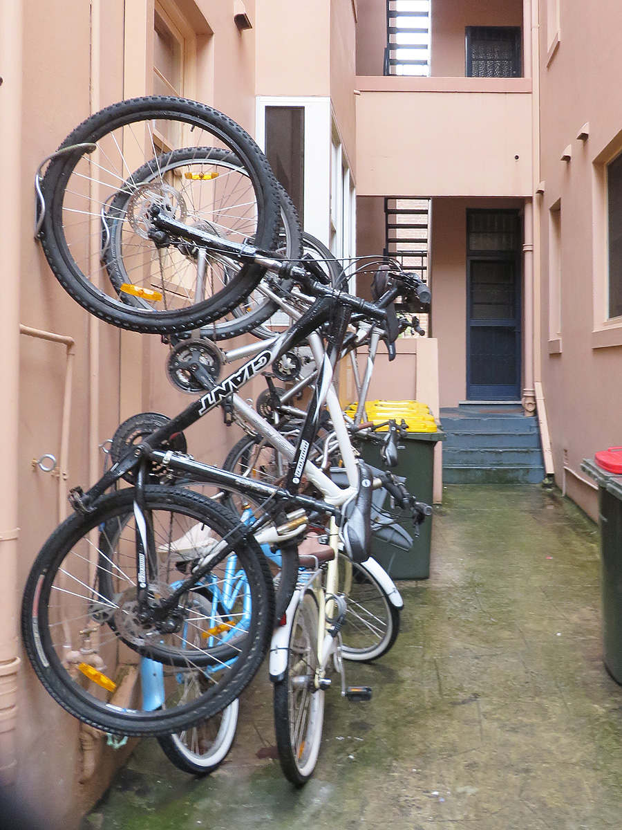 a parking lot with bikes stacked on a rack
