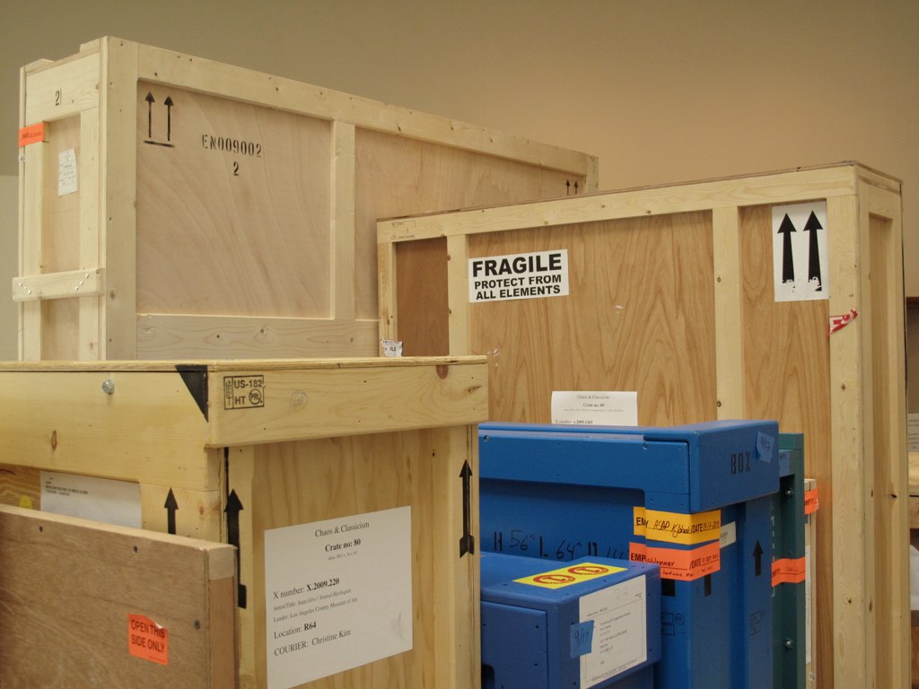 many different boxes and shelves in a storage room