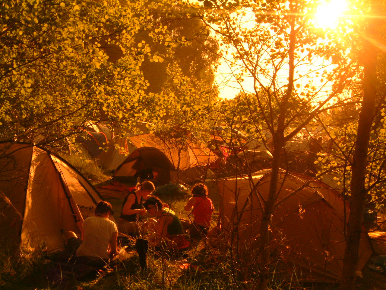 a group of people that are next to some tents