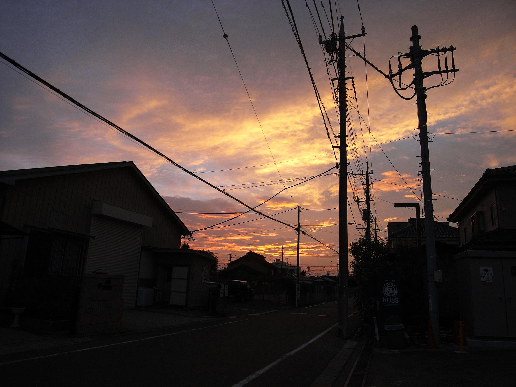 a view of sunset from an alley way