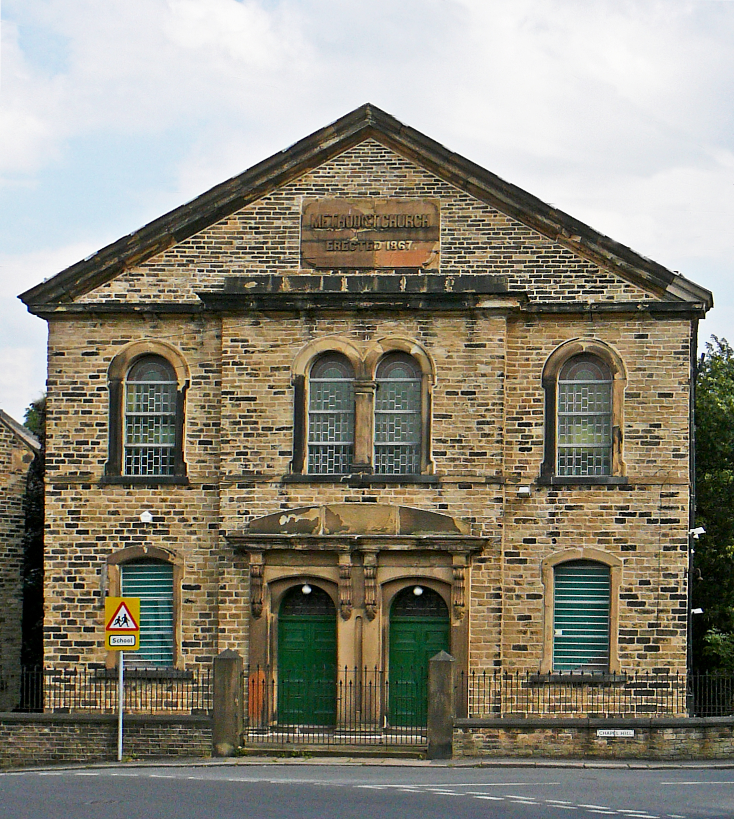 an old building with many windows and two signs