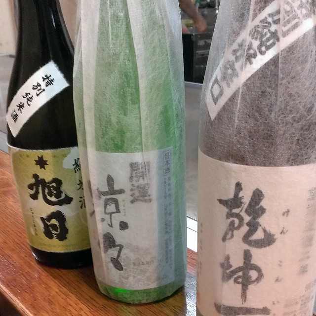 four bottles of sake on a table