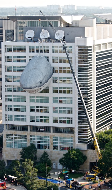 a large object is hanging off the side of a building