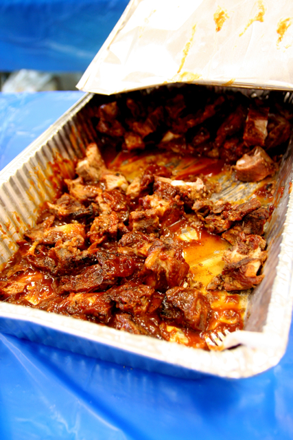 a large pan filled with meat and potatoes in a carton