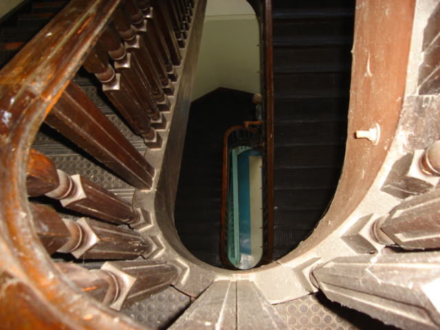 a set of metal stairs is shown through an opening in the ground