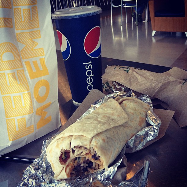 an image of a pita wrap and pepsi soda