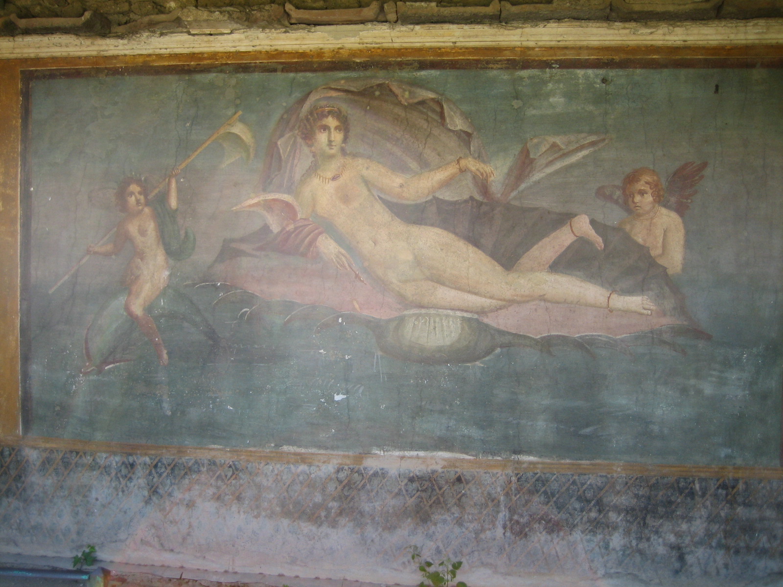 a painting depicting  women holding spears is shown in an old wall