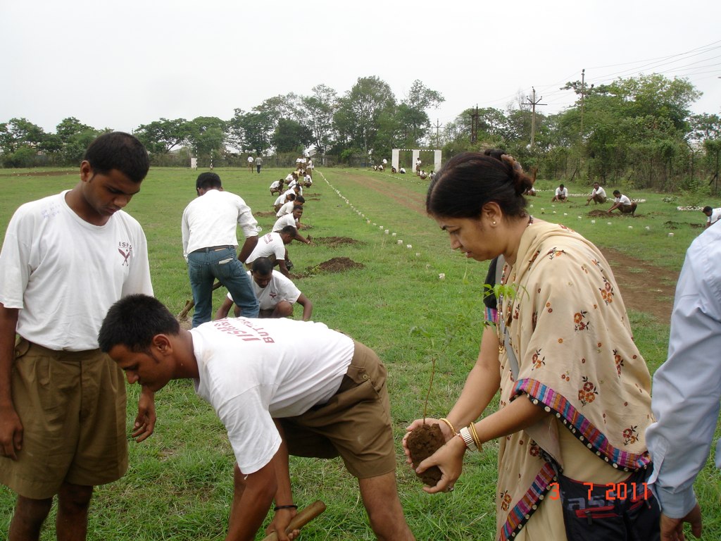 a woman looking at some small men on a field