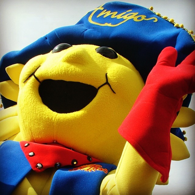 a stuffed animal with sunglasses, hat and gloves on