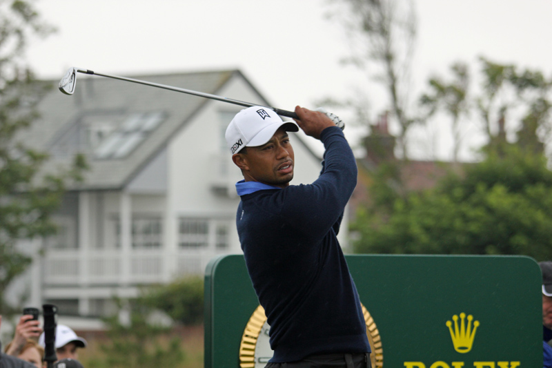 a man that is holding up a golf club