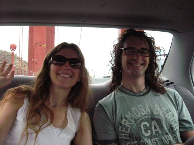 a man and a woman are sitting in the back seat of a car