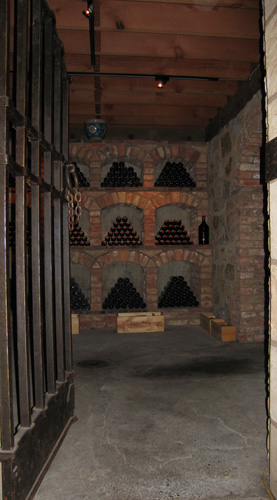 a doorway leads to an old room filled with bottles