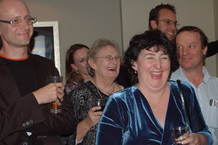 a group of people are laughing with one another