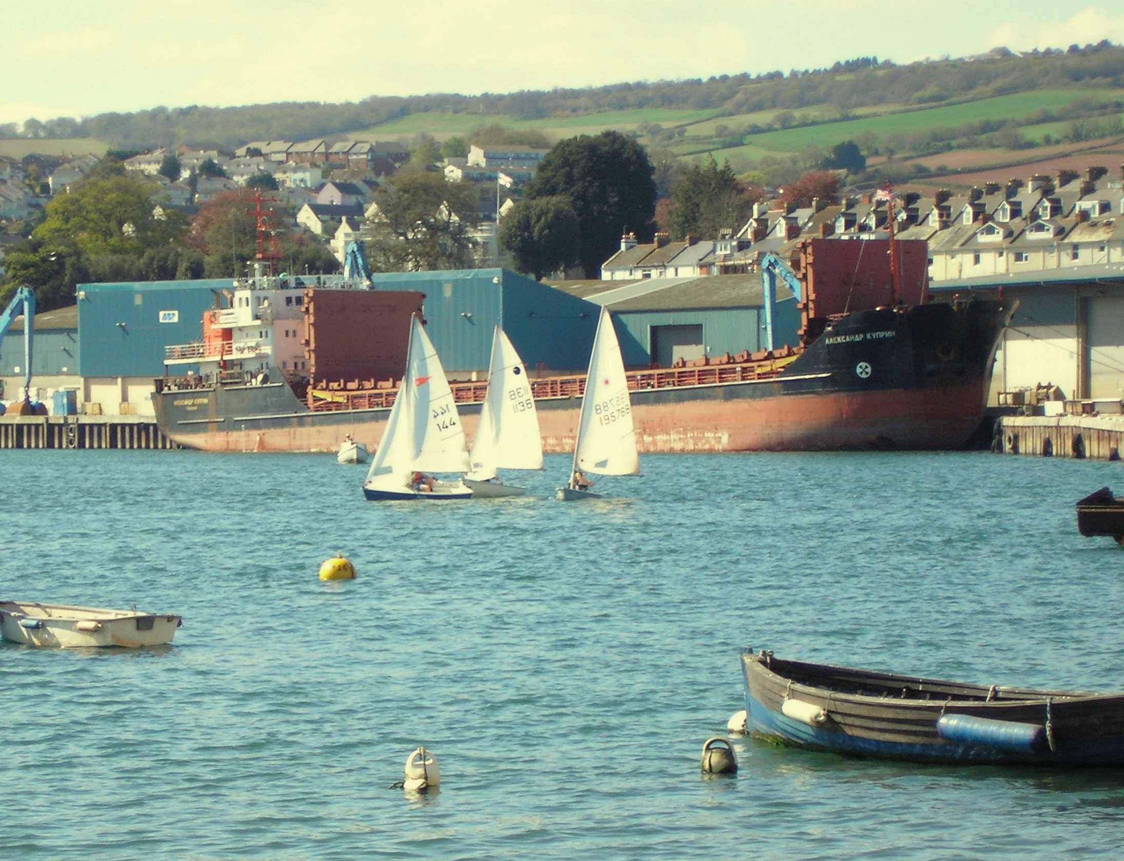 several boats in water next to some buildings