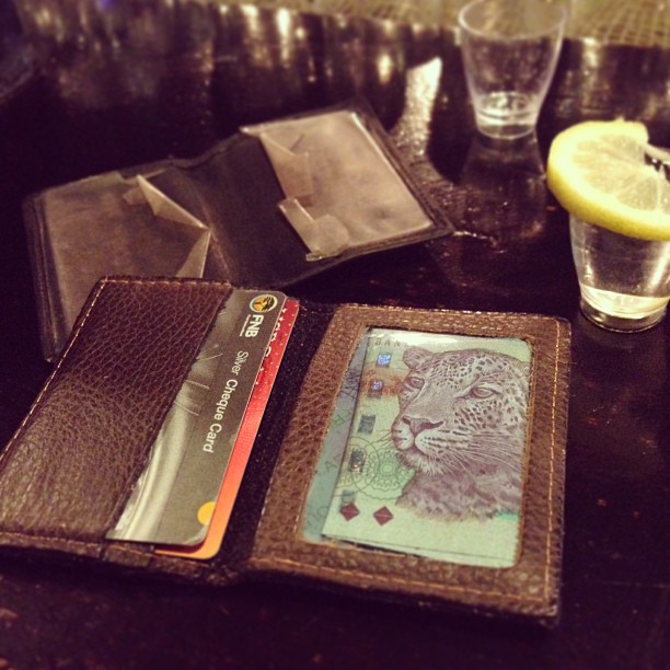 the cardholder on the table with a lemon, and two wallets are next to each other