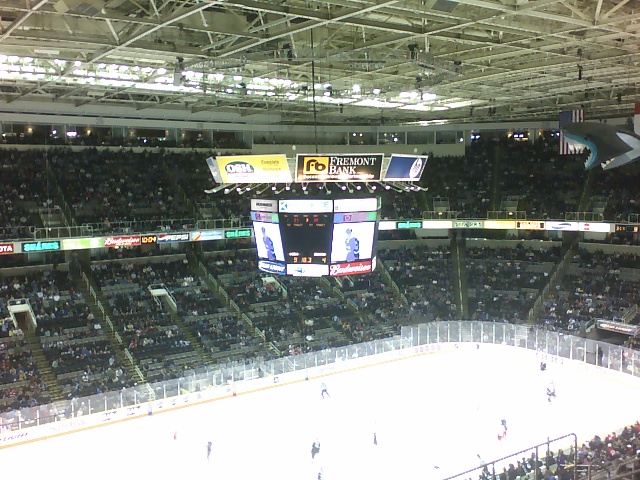 a large ice hockey stadium is crowded with spectators