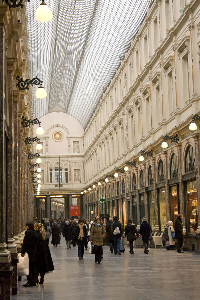 people walking through the large store with a glass ceiling