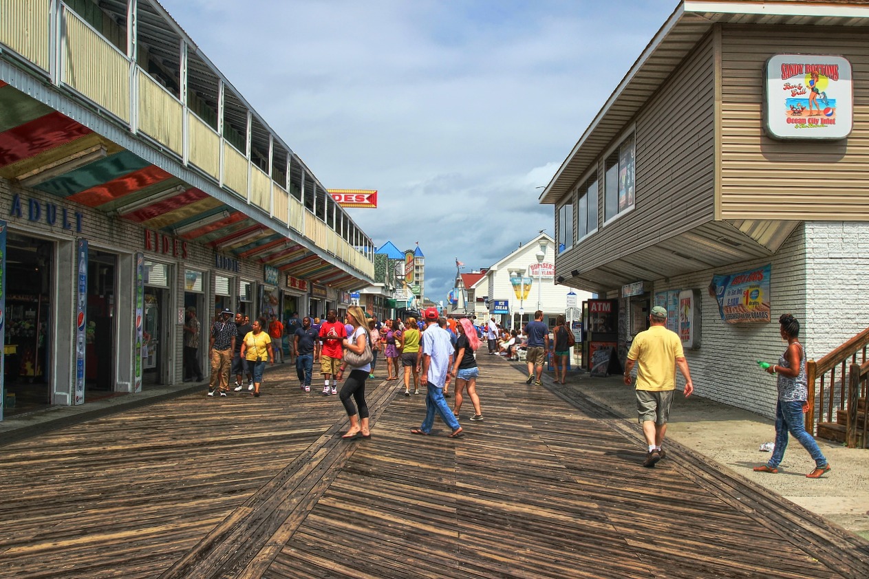 several people on boardwalk outside a toy store