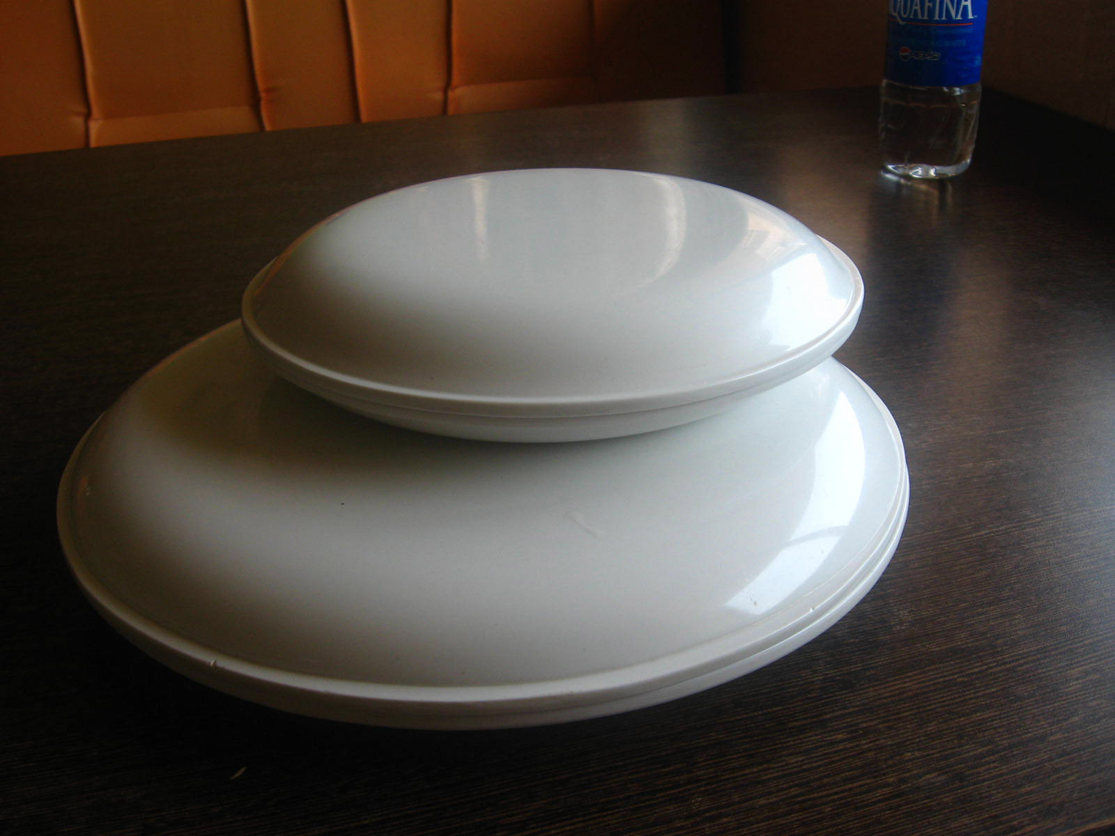 three white plates on a wooden table