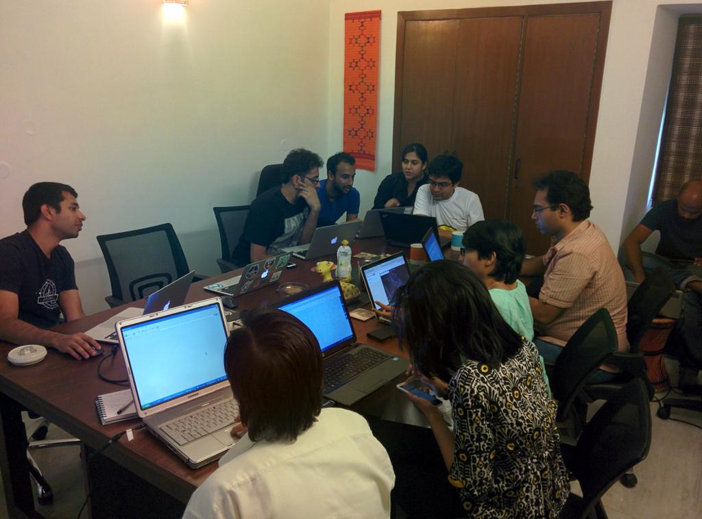 a group of people seated at a table using laptops