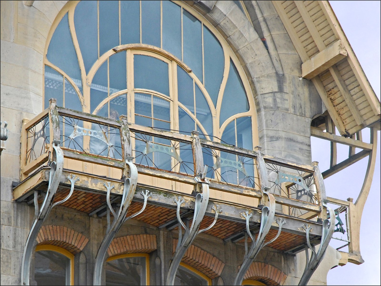 the balcony in front of the building has decorative iron railings