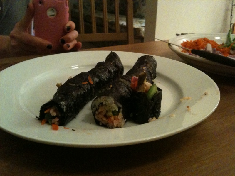 a sushi is arranged on a plate next to a bowl