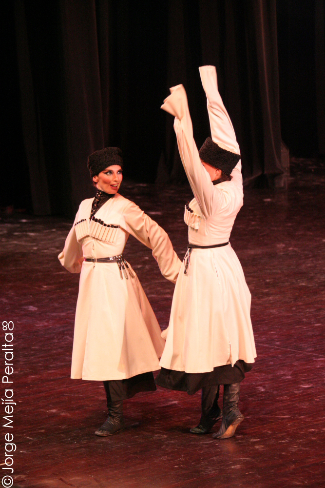 two people in dresses on a stage