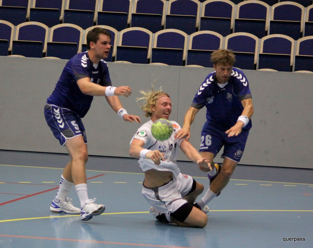 two men playing soccer and wearing jerseys on a court