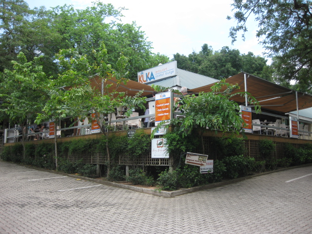 a building with trees and bushes surrounding it