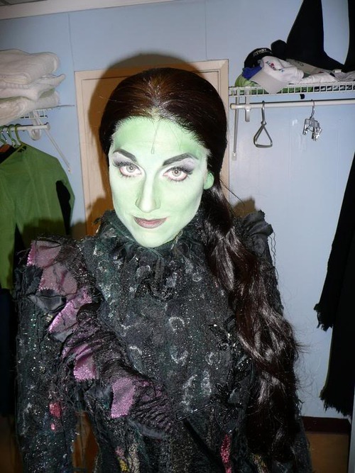 a woman wearing halloween makeup in a closet