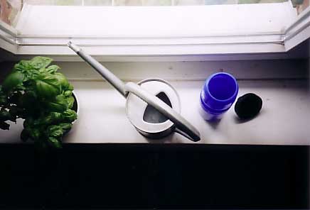 a pair of scissors and a plastic cup sit on a counter