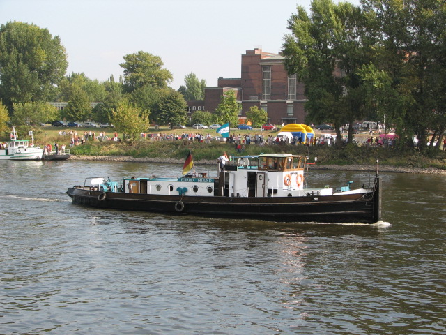 a black and white tugboat in a river