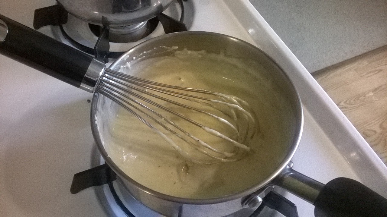 a sauce pot is being whisked with er
