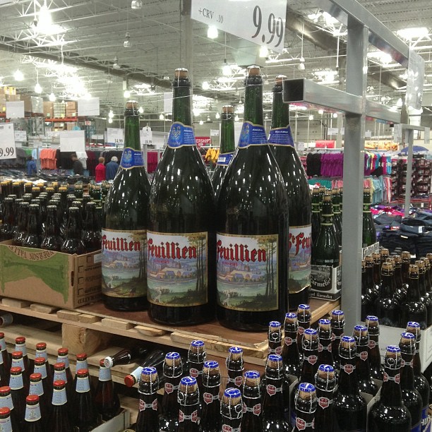 bottles of beer on shelves at a grocery store