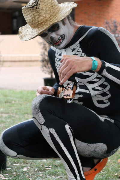 a man dressed up as skeleton and wearing a hat