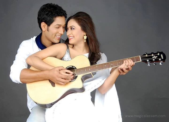 two people are smiling while playing guitars