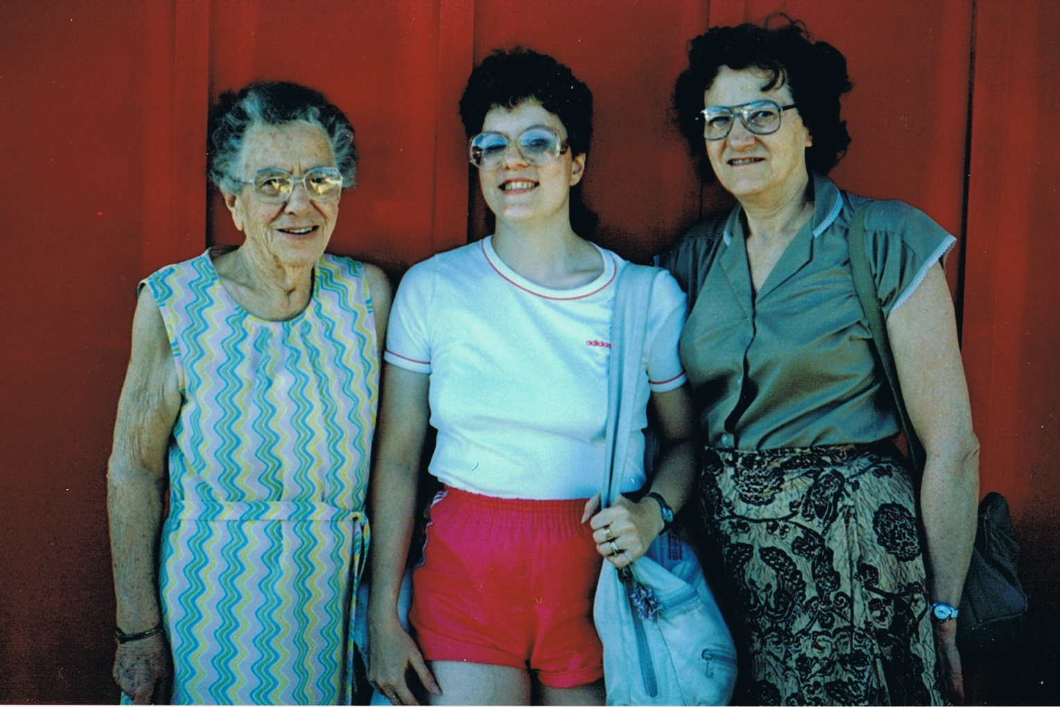 two woman and an old lady standing next to each other