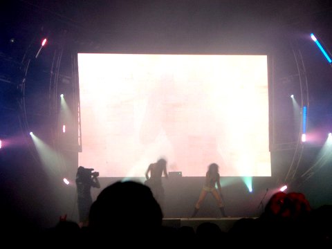 two people are on a stage with light effects