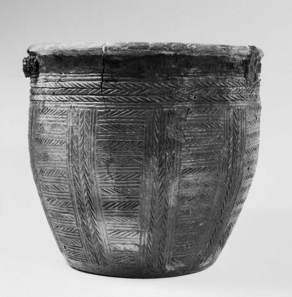 a vase that is made in the shape of a basket