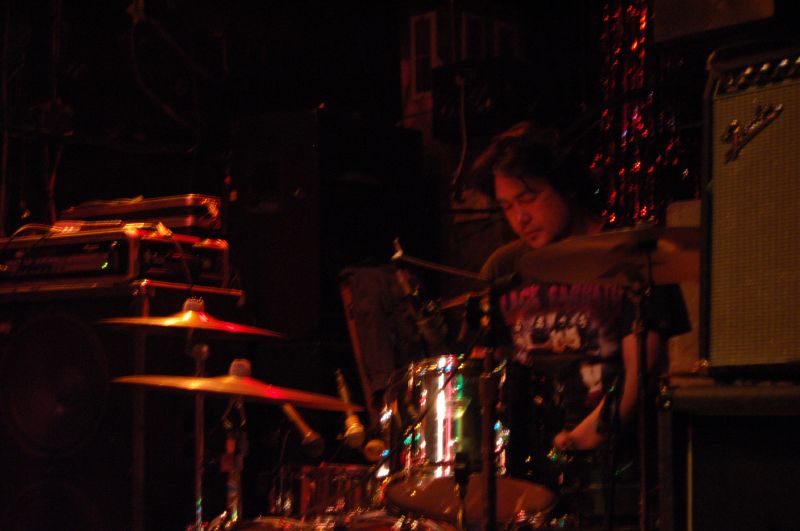 drummer and recording assistant performing on stage at a concert