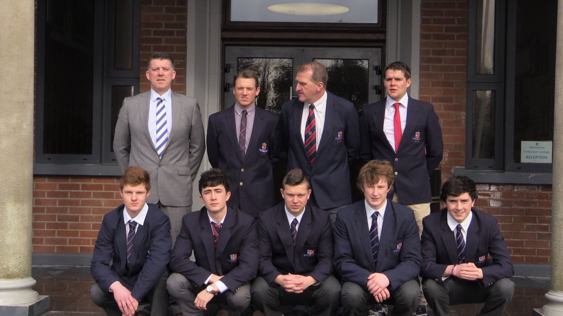 a group po of a team of men in suits and ties