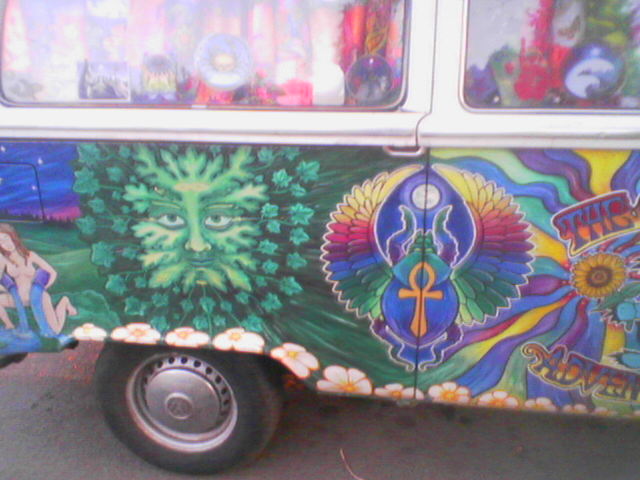 a colorfully painted van parked on the side of the road
