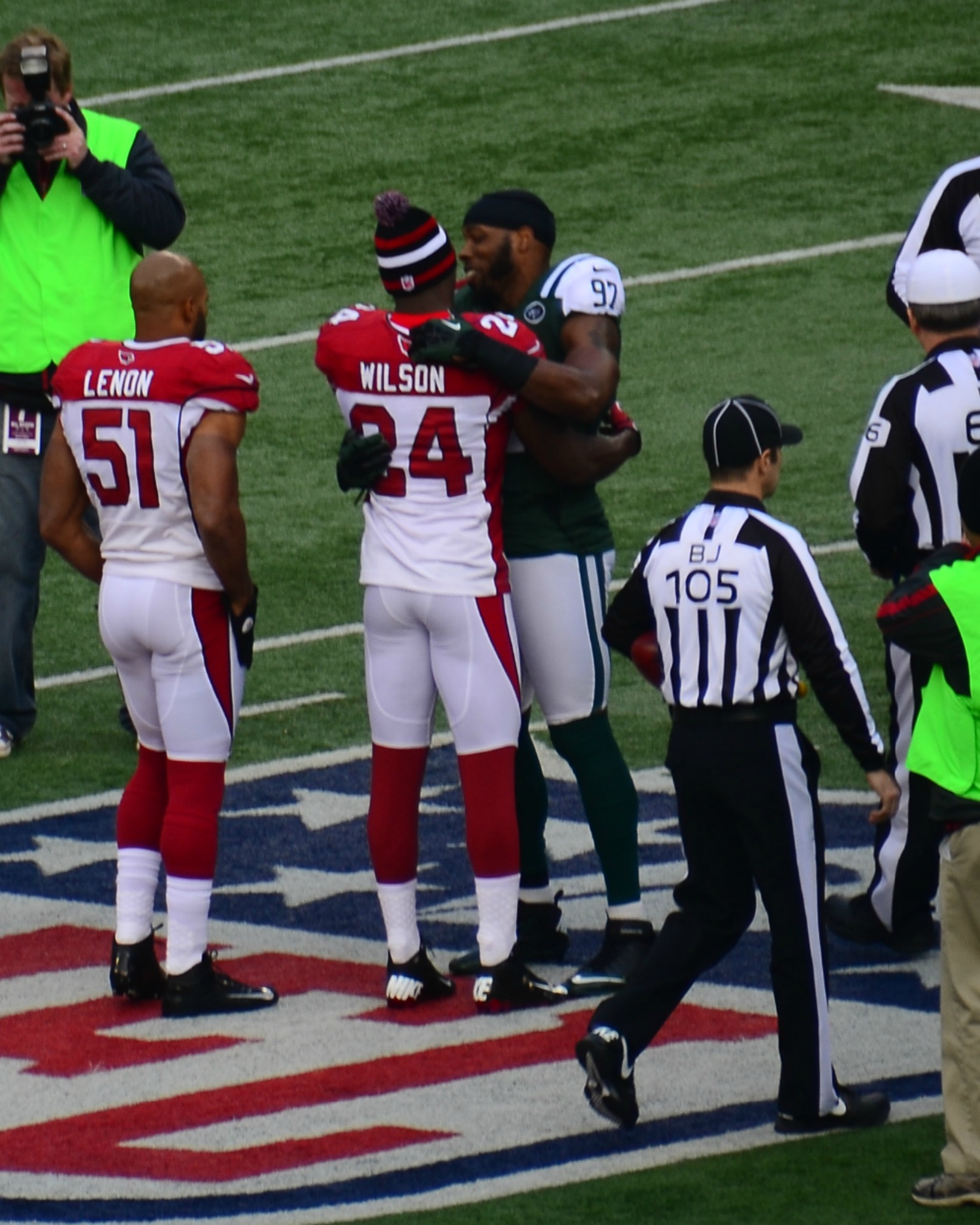 a group of football players standing on top of a field