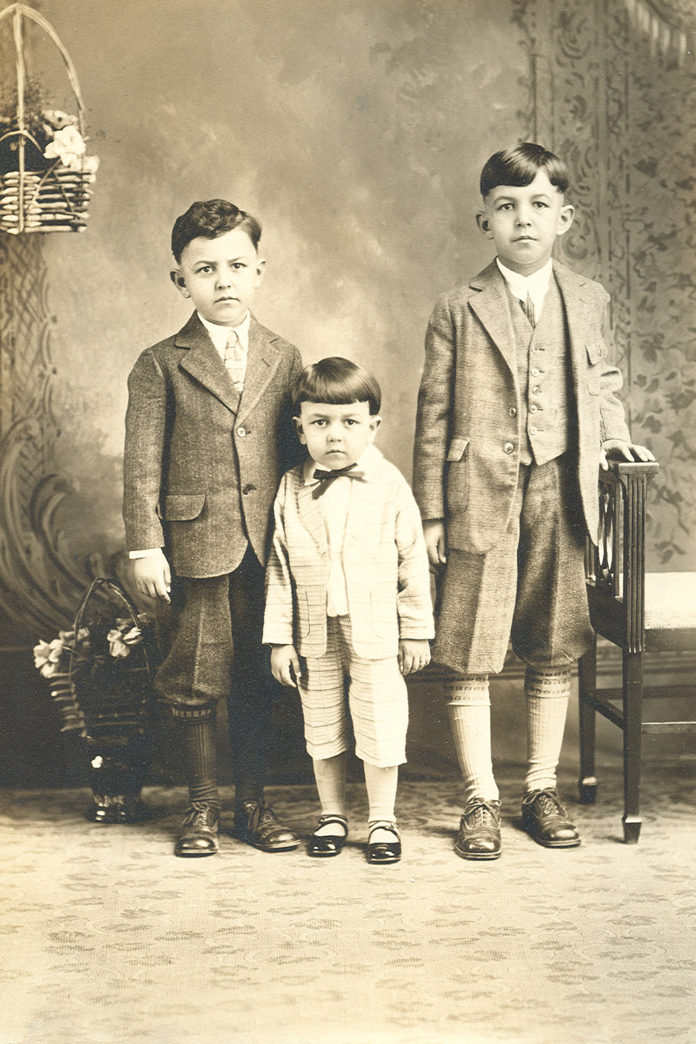 a group of three boys pose for a picture
