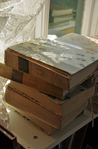 a stack of old books sitting on a counter