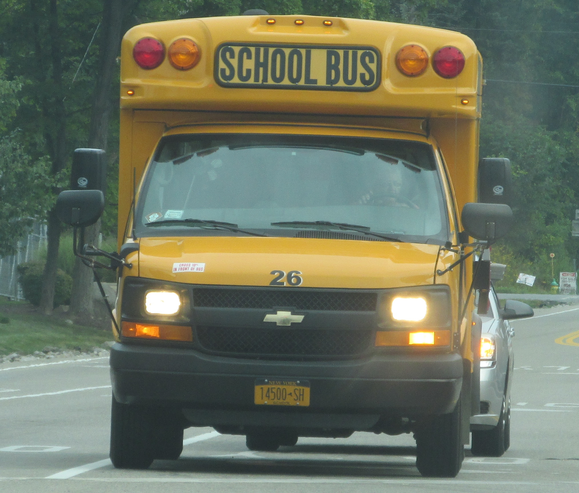 a school bus is driving down the street