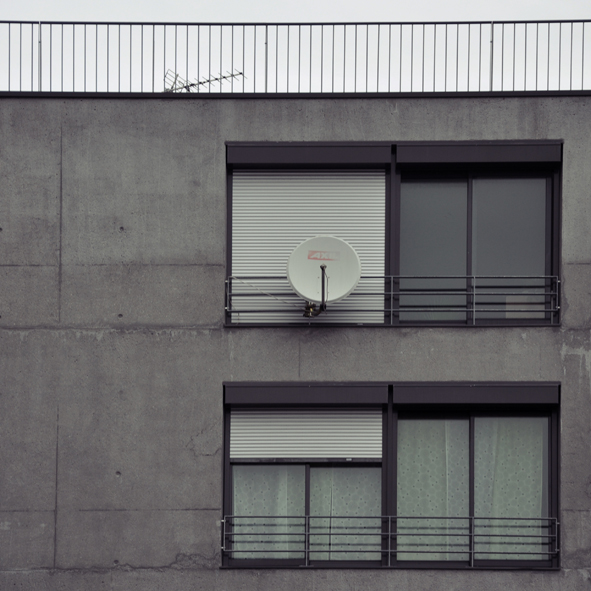a large satellite dish on top of an open window