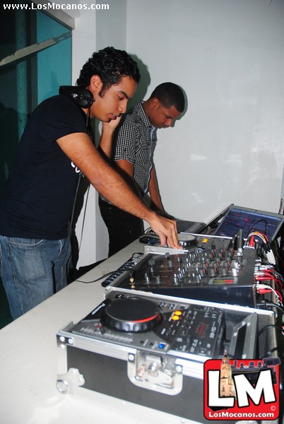 two men standing next to each other in front of sound equipment