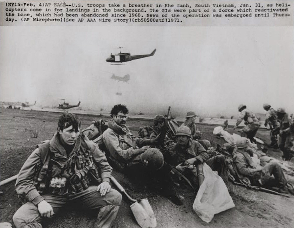 black and white pograph of men on the ground with parachute